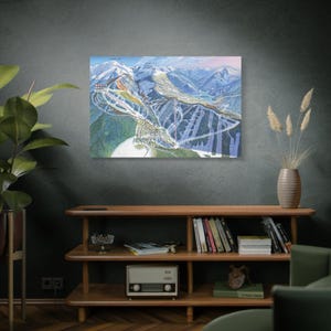 May include: A detailed illustration of a ski resort with a variety of runs and lifts. The illustration is printed on a white background and framed in a black frame.