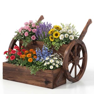 May include: A rustic wooden cart planter filled with a variety of colorful flowers. The cart features two levels of wooden boxes, each overflowing with blooms in shades of pink, yellow, red, orange, blue, and white. The cart has large wooden wheels.
