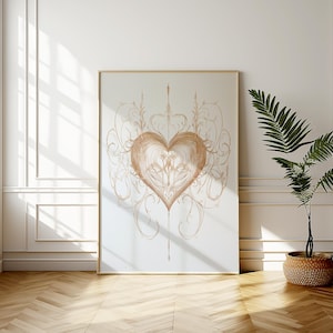 May include: A framed print of a heart-shaped design with intricate swirls and lines in a light brown colour. The design is on a white background.