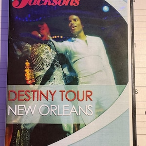 May include: DVD case for The Jacksons' Destiny Tour in New Orleans. The cover features a photo of the band members in performance attire. The title "Destiny Tour" is in red, and "New Orleans" is in white.