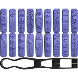May include: A set of 18 lavender-colored rubber stamps with various mystical symbols, including moons, stars, and geometric patterns. A black plastic handle is included for use with the stamps. The stamps are arranged in three rows of six.