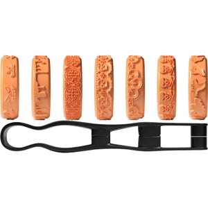 May include: Seven orange cylindrical clay rollers with various embossed patterns including skulls, ghosts, and floral motifs, arranged in a horizontal row above a black plastic handle tool designed to hold and rotate the rollers for imprinting.