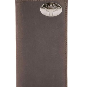 May include: A brown leather wallet with a silver Texas emblem. The wallet is rectangular and has a bi-fold design. The Texas emblem features a longhorn and the word "TEXAS".