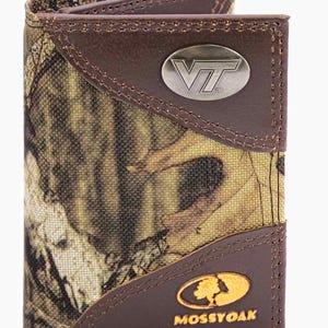 May include: A brown bi-fold wallet with a camouflage pattern and leather accents. The wallet features a silver metal logo with the letters "VT" and a gold oval logo with the text "MOSSY OAK".