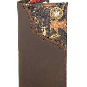 May include: Brown leather wallet with a camouflage accent and decorative stitching. The wallet features a 12 GA emblem and has slots for cards and cash. The wallet is made of leather.