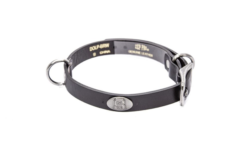 May include: Black leather dog collar with a silver-colored buckle and a metal ring for leash attachment. The collar has a small, oval metal emblem with a logo. The text "DOLP-BRN" and "GENUINE LEATHER" are visible.