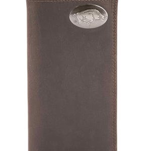 May include: A brown leather wallet with a silver oval emblem featuring a detailed image of a Razorback hog. The wallet is rectangular and has a vertical bi-fold design. The edges are stitched with a matching brown thread.