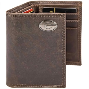 May include: Brown leather wallet with a silver-colored emblem. The wallet is open, revealing card slots and a bill compartment. The leather has a distressed look, and the stitching is visible. A classic accessory for carrying essentials.