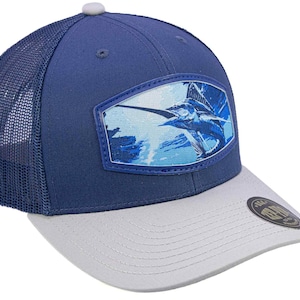 May include: A blue and white baseball cap with a mesh back. The front of the cap features a patch with a blue and white illustration of a swordfish. The brim is light grey.