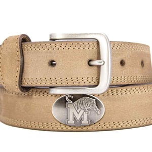 May include: A tan leather belt with a silver buckle and a decorative oval buckle featuring a tiger and the letter "M". The belt has stitched edges and a classic design.
