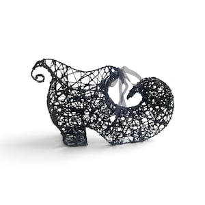 May include: A decorative shoe-shaped sculpture crafted from black wire with a glittery finish. The design features an open lattice structure, a curled toe, a flared heel, and a sheer grey ribbon tied in a bow near the opening of the shoe.