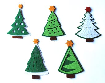 May include: Five felt Christmas tree ornaments in various designs. Two green trees with white accents, one white tree with green accents, and two green trees with yellow star accents.