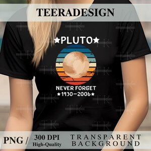 May include: Black t-shirt with a Pluto graphic. The design features the word "PLUTO" with stars, a planet illustration, and the text "NEVER FORGET 1930-2006" in white. The shirt has a round neck and short sleeves.