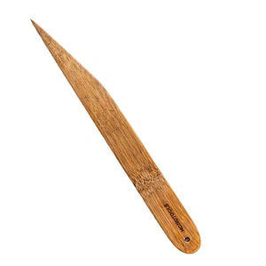 May include: A wooden bamboo tool with a pointed end and a rounded handle. The tool is light brown with visible wood grain and the text "NONOTOOLS" is printed on the handle.