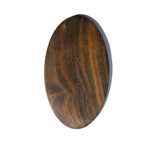 May include: Oval-shaped wooden massage tool with a natural wood grain pattern. The tool is primarily brown with streaks of orange and dark brown. The text "HONGTOOLS" is embossed on the surface.