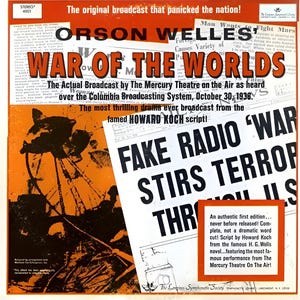 May include: A vintage record album cover featuring a black and white image of a Martian tripod against an orange background. The album title is "Orson Welles' War of the Worlds" with the text "The Actual Broadcast by The Mercury Theatre on the Air as heard over the Columbia Broadcasting System, October 30, 1938".