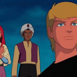 May include: Three cartoon characters, a woman with red hair wearing a white and blue shawl, a man with a turban wearing a purple and gold robe, and a man with blond hair wearing a black shirt. The characters are standing against a blue background.