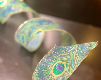 Peacock feather ribbon — 2.5" wide, jewel‑tone with gold trim, wired edge, sold by yard (2.5‑yd increments)