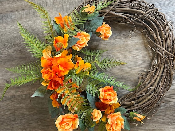 Beautiful all seasons Rose wreath.  Natural grapevine base decorated with silk hydrangea, lacy fern leaves, and variegated silk roses.