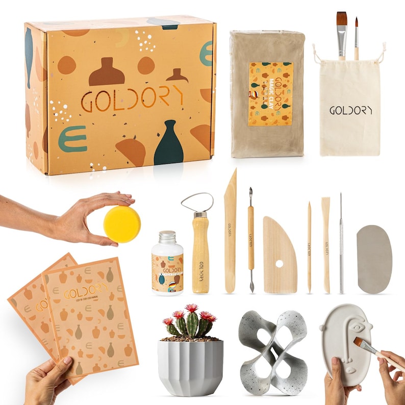 May include: A pottery kit with a box, clay, tools, and a sponge. The box is brown with a pattern of abstract shapes and the text "Goldory". The clay is in a brown paper bag with the text "Goldory Magic Clay". The tools include a wooden sculpting tool, a metal sculpting tool, a wooden scraper, a wooden rib, a wooden needle tool, a wooden sponge, and a wooden brush. The sponge is yellow.