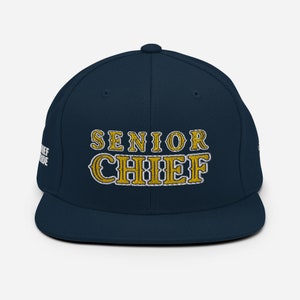 May include: A navy blue baseball cap with a gold embroidered design that says "Senior Chief".