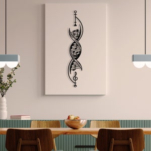 May include: Black metal wall art featuring a double helix design with musical notes incorporated into the structure. The art piece is hanging on a light beige wall in a dining room setting.