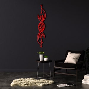 May include: Red metal wall art sculpture of a double helix DNA strand with musical notes incorporated into the design. The sculpture is mounted on a black wall in a modern living room setting.