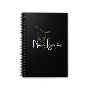 May include: Black spiral-bound notebook with the words "Nurse Injector" in white script. A gold line drawing of a face and hat is above the text. The notebook is on a white surface.