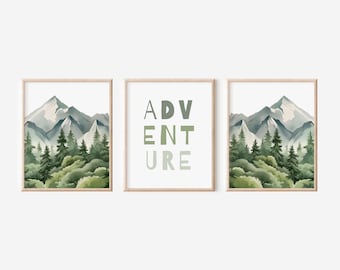 May include: Three framed prints featuring a watercolour mountain landscape and the word "ADVENTURE" in green and blue lettering. The prints are in wooden frames.