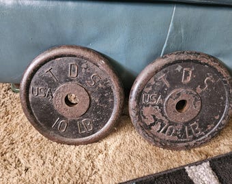 Dos discos de pesas estándar TDS vintage de 10 libras cada uno.