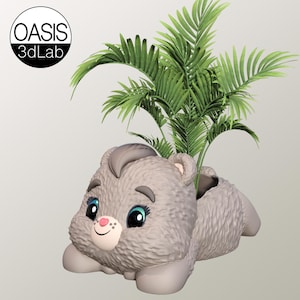 May include: A gray, furry, cartoon bear planter with a smiling face and blue eyes. A green palm plant is growing out of the planter.