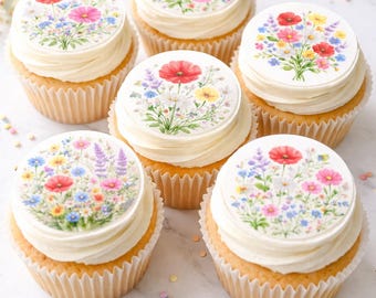 May include: Five cupcakes with white frosting, each topped with a circular edible wafer featuring a colorful watercolor illustration of a wildflower bouquet including red poppies, yellow daisies, and blue cornflowers on a white background.