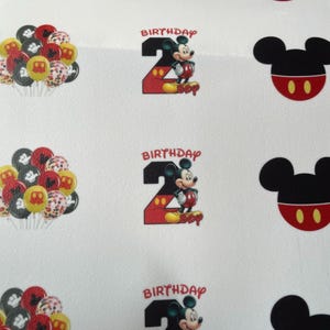 May include: Four sheets of white paper with Mickey Mouse themed birthday party decorations. Each sheet features a red number two with Mickey Mouse standing on top of it. The number two has white polka dots. The text "Birthday Boy" is written below the number. Each sheet also features a black Mickey Mouse head with red ears and two yellow circles for eyes. The sheets are decorated with a cluster of colorful balloons with Mickey Mouse designs.