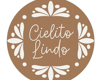 May include: A circular brown sticker featuring the white text Cielito Lindo in a cursive script. The design is framed by a symmetrical white floral pattern consisting of petal shapes and small dots arranged around the central text.