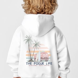May include: White hooded sweatshirt with a graphic print of a vintage van, palm trees, and surfboards. The text "THE POGUE LIFE" is printed below the graphic, with the words "OUTER BANKS - NORTH CAROLINA" printed below the text.