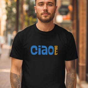 May include: Black t-shirt with the words "Ciao Bella" in blue and yellow. The shirt has a crew neck and short sleeves. The text is in a bold, sans-serif font.