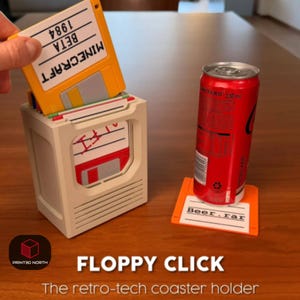 May include: A retro-tech coaster holder shaped like a computer, with a yellow floppy disk labeled "MINECRAFT BETA 1984" being inserted. An orange floppy disk coaster with "Beer.rar" text supports a red soda can. The holder is off-white.