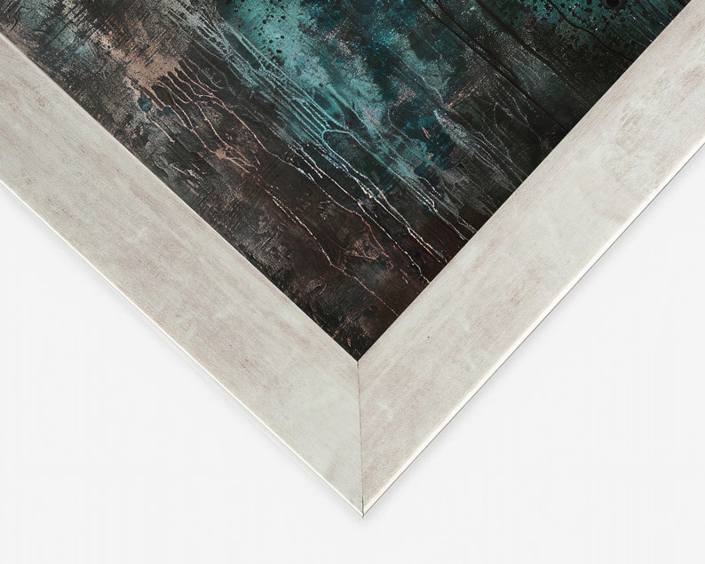 May include: Close-up of the corner of a white wood picture frame. The frame has a slightly distressed finish and surrounds a dark blue and brown abstract painting.