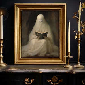 May include: A framed artwork depicts a ghost reading a book, with a gold frame. The ghost is draped in white fabric. The artwork is flanked by lit candles in gold candle holders. The text "UNCANNY GARDENS" is visible.