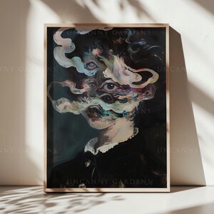 May include: A framed art print featuring a surreal portrait. The artwork depicts a figure with multiple eyes and swirling, colorful smoke-like forms obscuring the face. The figure is dressed in a dark garment with a white collar. The print is displayed on a light-colored surface.