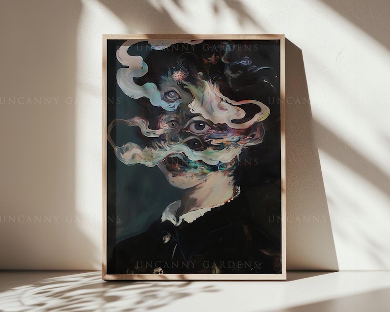 May include: A framed art print featuring a surreal portrait. The artwork depicts a figure with multiple eyes and swirling, colorful smoke-like forms obscuring the face. The figure is dressed in a dark garment with a white collar. The print is displayed on a light-colored surface.