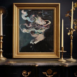 May include: A framed surrealist portrait with a gold frame, depicting a figure with multiple eyes and swirling, colorful smoke-like forms. The artwork is displayed on a dark surface, accompanied by lit candles in brass candlesticks. The text "UNCANNY GARDENS" is visible.