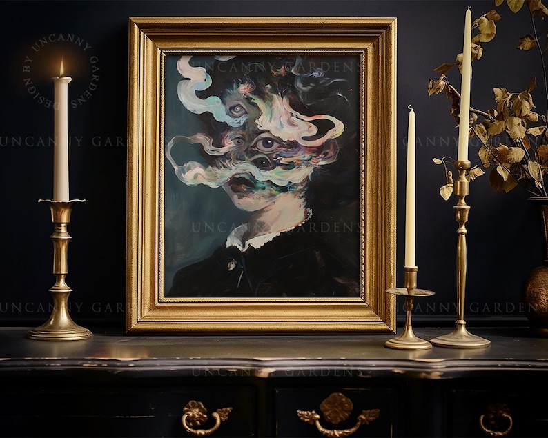 May include: A framed surrealist portrait with a gold frame, depicting a figure with multiple eyes and swirling, colorful smoke-like forms. The artwork is displayed on a dark surface, accompanied by lit candles in brass candlesticks. The text "UNCANNY GARDENS" is visible.