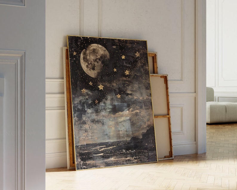 May include: A framed canvas print with a dark blue background featuring a large, full moon and gold stars. The moon is in the center of the image and the stars are scattered around it. The canvas has a textured, abstract look.