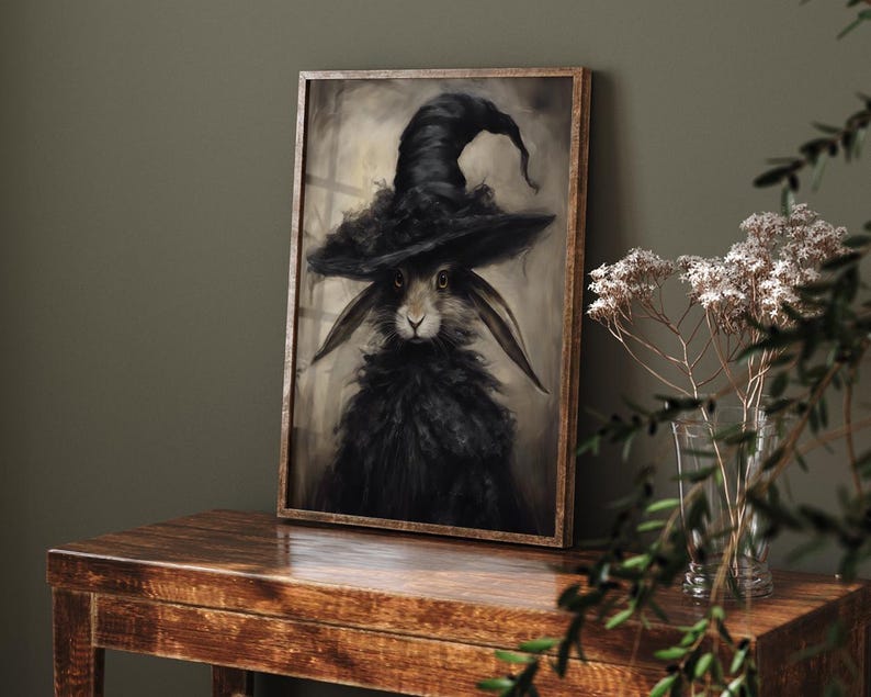 May include: A black rabbit wearing a black witch's hat with a wide brim. The rabbit has a serious expression and is looking directly at the viewer. The background is a light brown color.