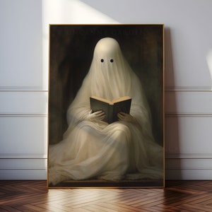 May include: A framed print featuring a ghost draped in white fabric, reading a book. The ghost has two black eyes and is set against a dark background. The words "UNCANNY GARDENS" are printed at the top of the print.