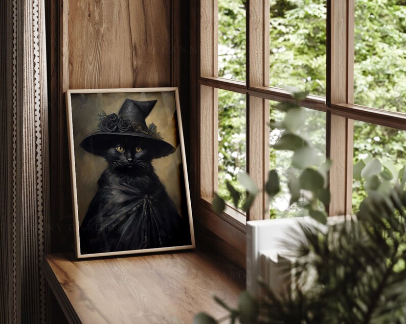 May include: A black cat wearing a witch's hat with black roses and a black cape. The cat is looking directly at the viewer. The image is framed in a wooden frame.