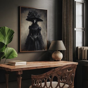 May include: A framed artwork depicts a figure in a black plague doctor costume with a wide-brimmed hat adorned with roses. The artwork hangs above a wooden desk with a lamp and books, creating a gothic and vintage aesthetic.