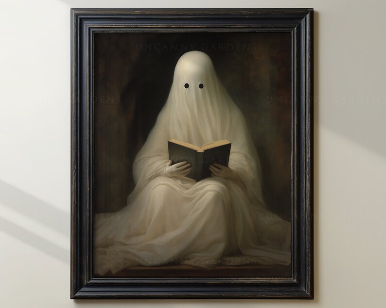 May include: Framed artwork featuring a ghost draped in white fabric, reading a book. The ghost has two black eye holes. The artwork is in a black frame and has the text "UNCANNY GARDENS" at the top.