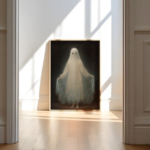 K&ouml;nnte beinhalten: Ein gerahmtes Gem&auml;lde eines Geistes, der ein wei&szlig;es Kleid mit einem blauen und wei&szlig;en Sternenmuster tr&auml;gt. Der Geist steht in einem dunklen Raum mit einem Licht, das auf ihn scheint.